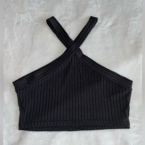 Crop top, black, high neck with crisscross straps.